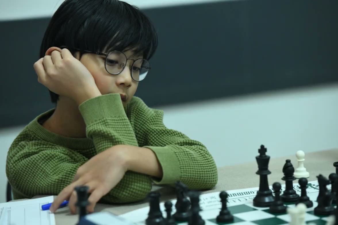 Lucas Yao studying the position at a tournament chessboard